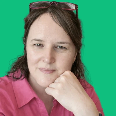 Jennifer Lewis, co-founder of P&J PitchWorks Co., in a pink top with her chin resting on her hand